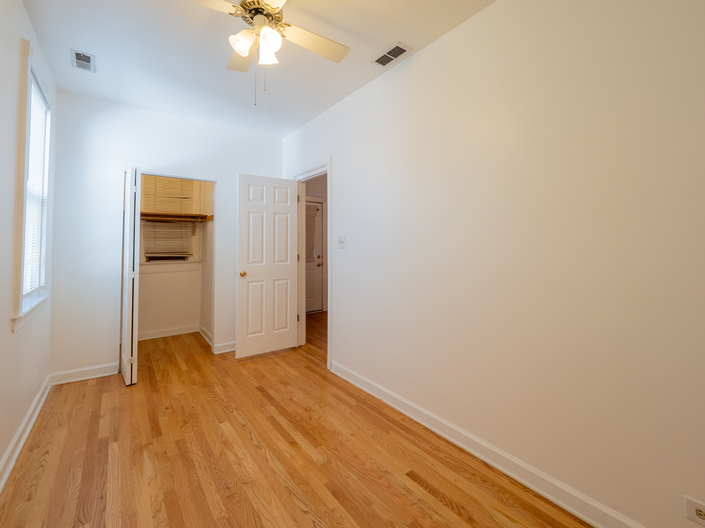 1920 West School Street Chicago, IL 60657 - Photo 30 of 36 wooden floor in an empty room with a bathroom