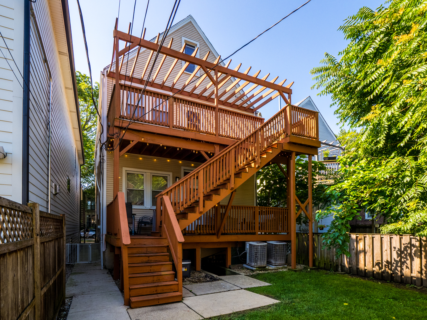 1920 West School Street Chicago, IL 60657 - Photo 36 of 36 a view of an house with wooden stairs and deck