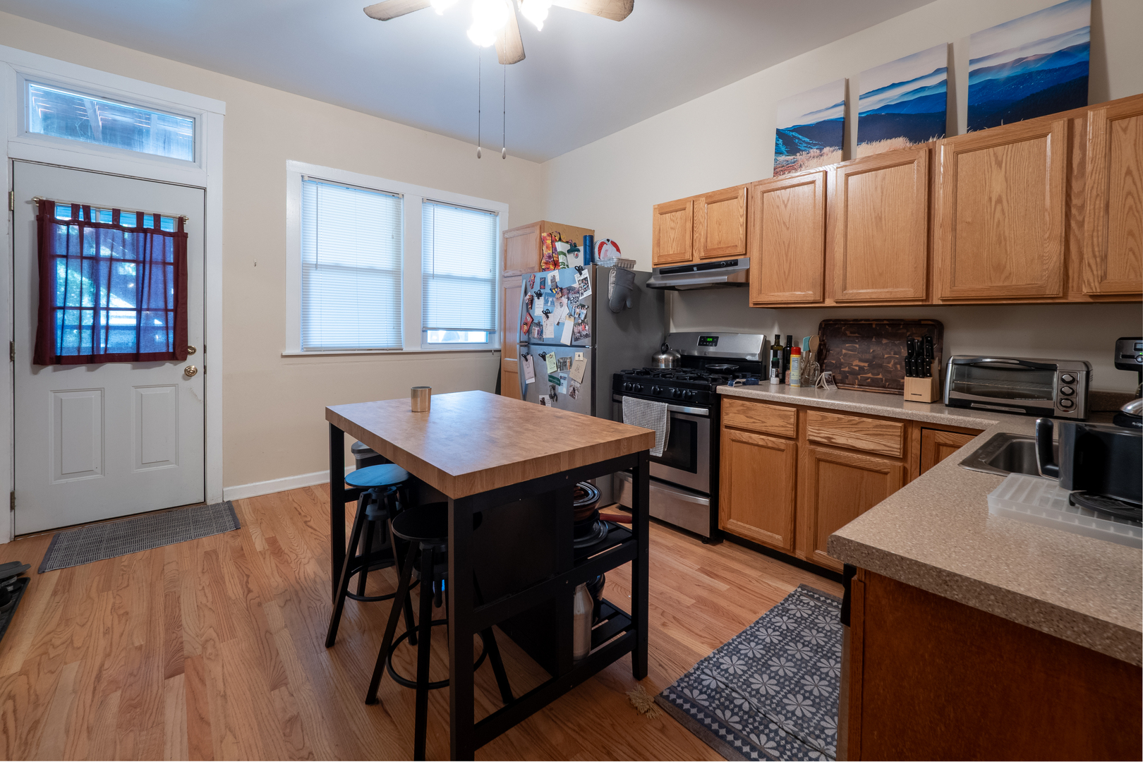 1920 West School Street Chicago, IL 60657 - Photo 6 of 36 a kitchen with stainless steel appliances granite countertop a stove a sink dishwasher and cabinets with wooden floor