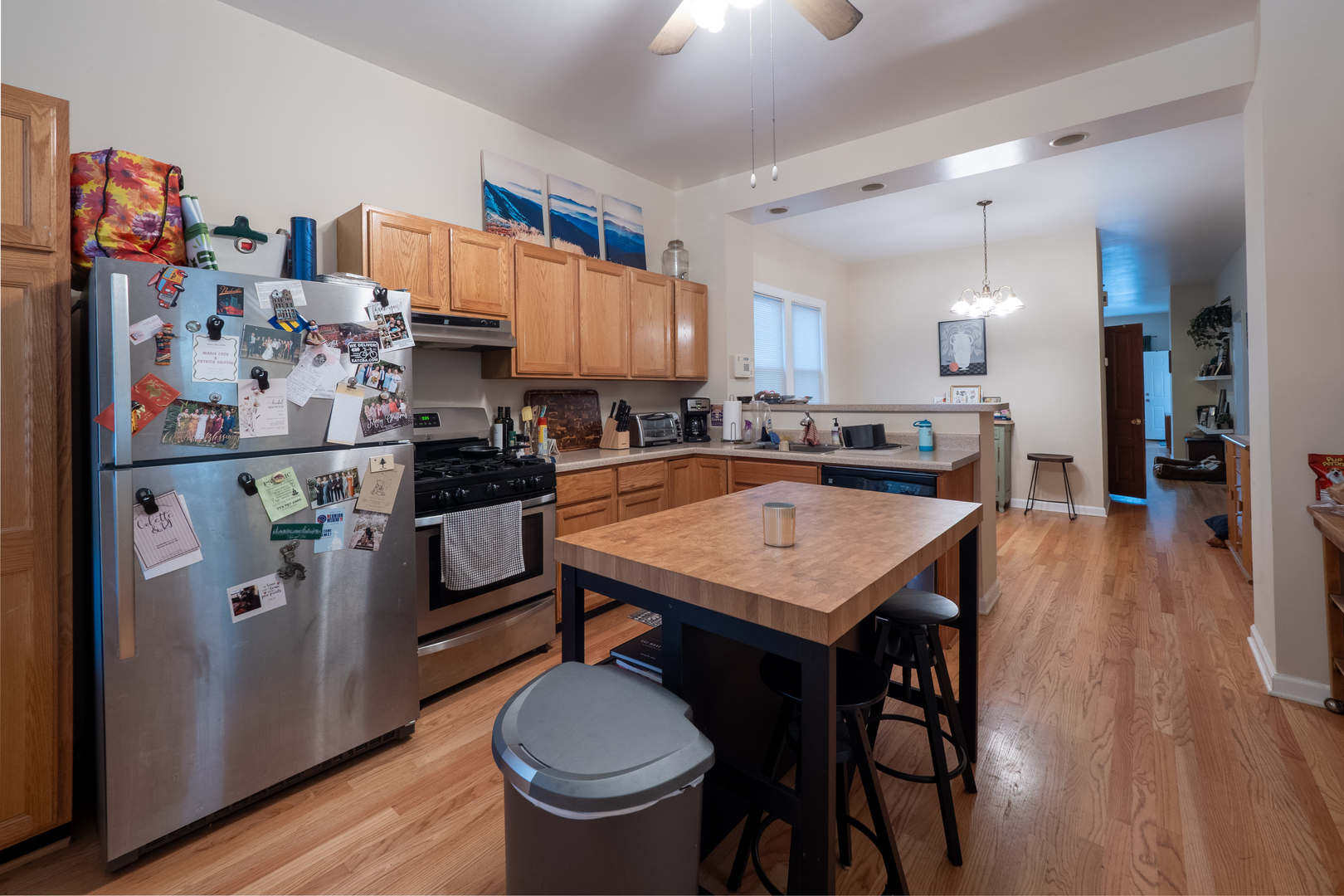 1920 West School Street Chicago, IL 60657 - Photo 7 of 36 a room with stainless steel appliances a table chairs and wooden floor