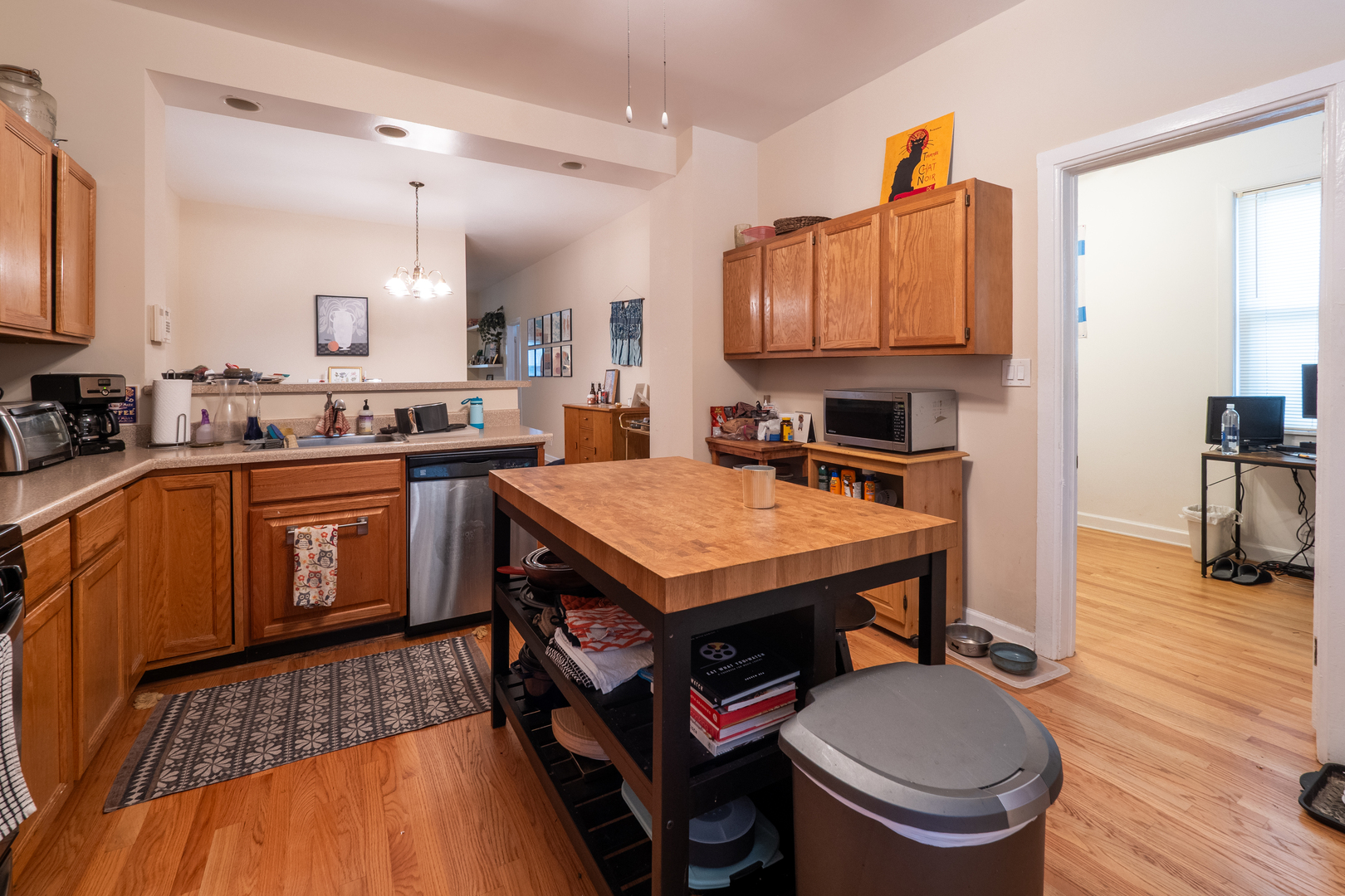 1920 West School Street Chicago, IL 60657 - Photo 8 of 36 a kitchen with a stove a sink dishwasher and a stove with wooden floor