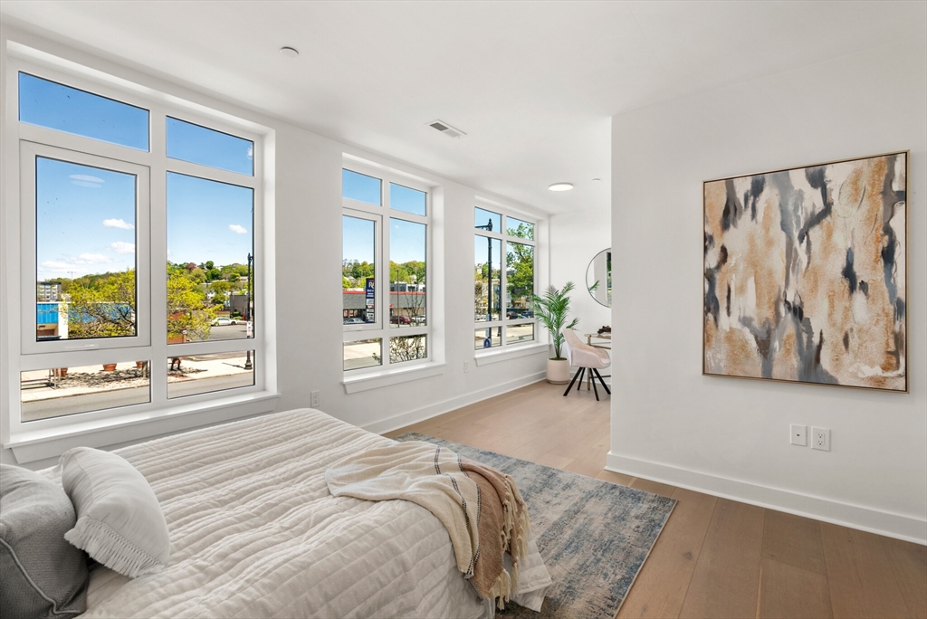 917 Bennington Street, Unit 301 Boston, MA 02128 - Photo 11 of 17 a bed room with a bed and a large window