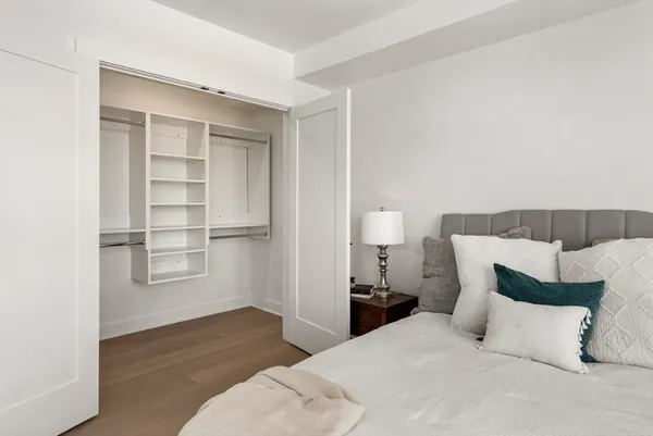 a bedroom with a bed and wooden floor