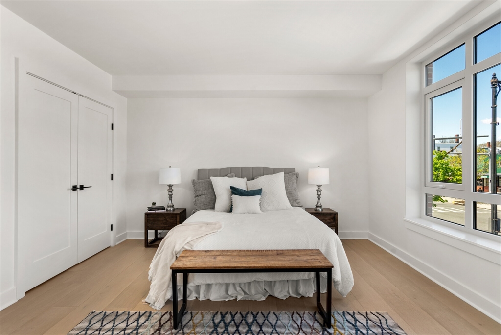 917 Bennington Street, Unit 301 Boston, MA 02128 - Photo 10 of 17 a bedroom with a bed and a window with outer view