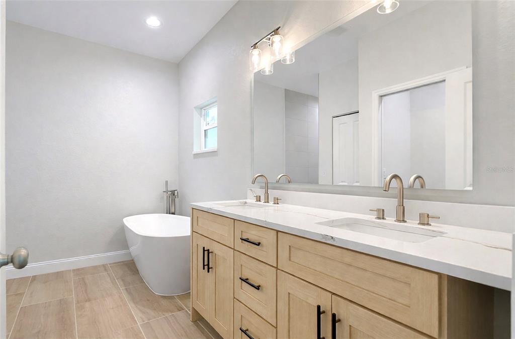 6231 Rowe Street Englewood, FL 34224 - Photo 11 of 14 a bathroom with a double vanity sink mirror and toilet