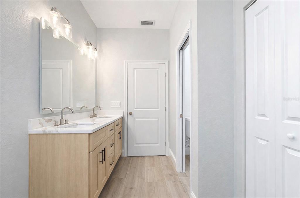 6231 Rowe Street Englewood, FL 34224 - Photo 12 of 14 a bathroom with a double vanity sink and mirror
