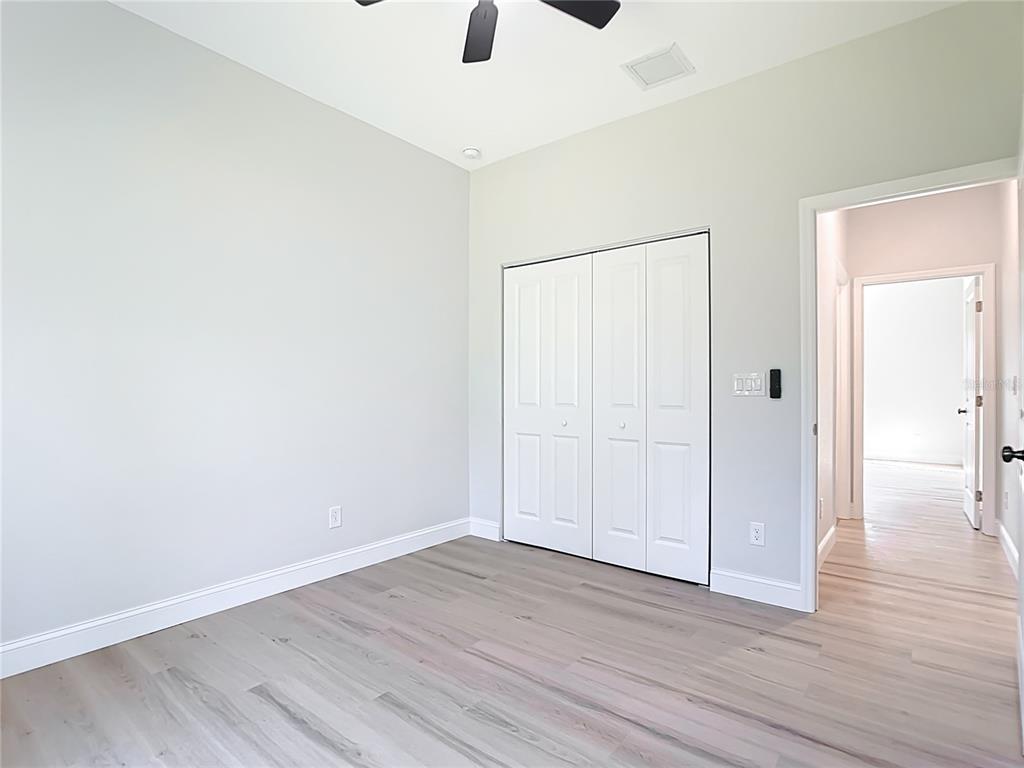 6231 Rowe Street Englewood, FL 34224 - Photo 13 of 35 an empty room with wooden floor