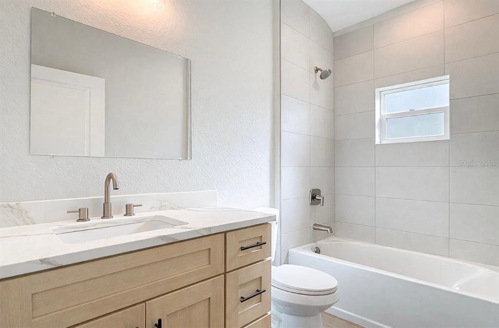 6231 Rowe Street Englewood, FL 34224 - Photo 14 of 14 a bathroom with a sink a toilet and a bathtub