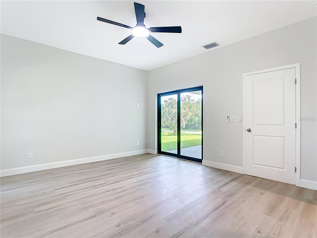 6231 Rowe Street Englewood, FL 34224 - Photo 17 of 35 wooden floor in an empty room with a window