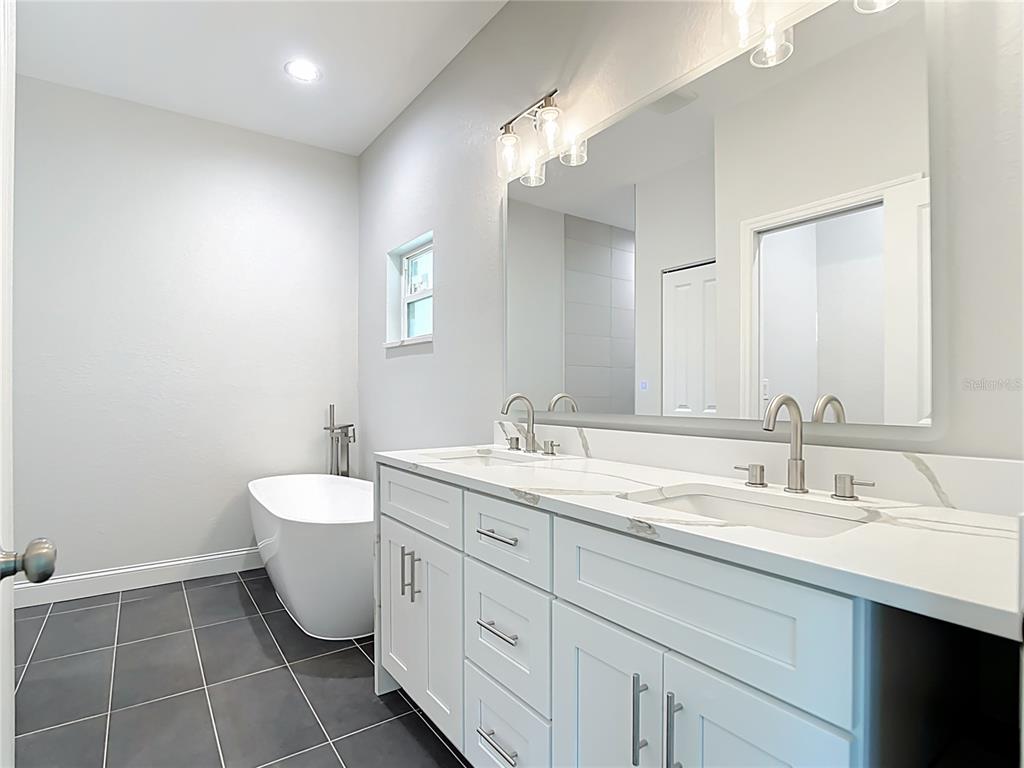 6231 Rowe Street Englewood, FL 34224 - Photo 20 of 35 a bathroom with a double vanity sink mirror and toilet