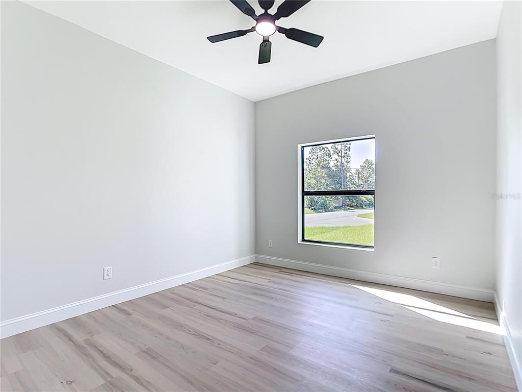 6231 Rowe Street Englewood, FL 34224 - Photo 25 of 35 an empty room with wooden floor and window