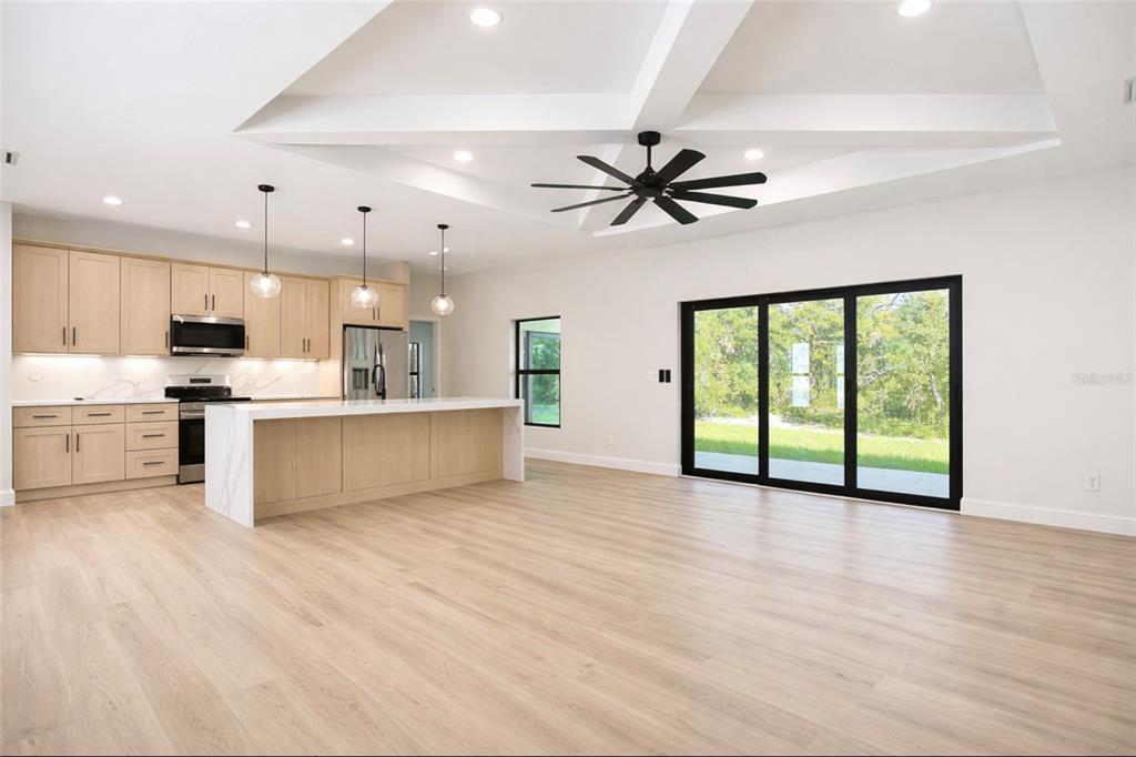 6231 Rowe Street Englewood, FL 34224 - Photo 3 of 14 a view of an empty room with kitchen appliances and a large window