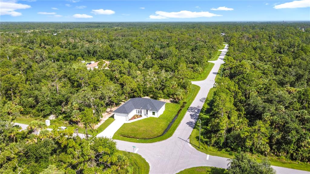 6231 Rowe Street Englewood, FL 34224 - Photo 34 of 35 a view of a yard with an outdoor space and seating area