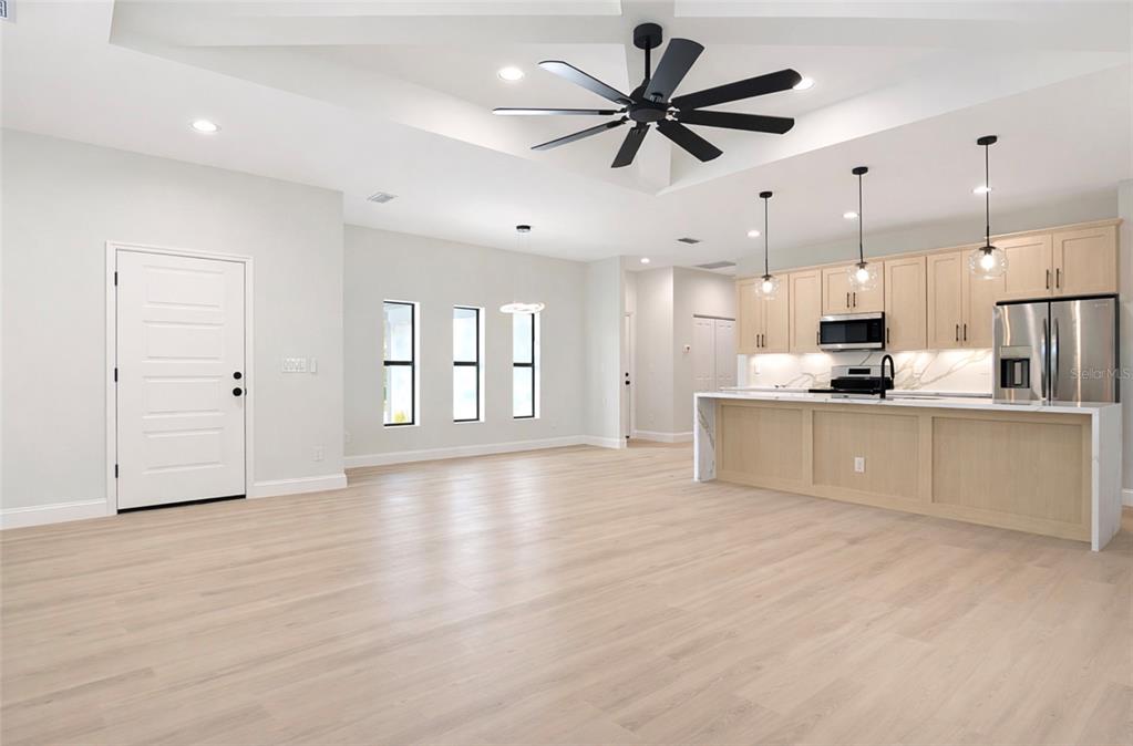 6231 Rowe Street Englewood, FL 34224 - Photo 4 of 14 a view of a kitchen with kitchen island a counter top space stainless steel appliances and a ceiling fan