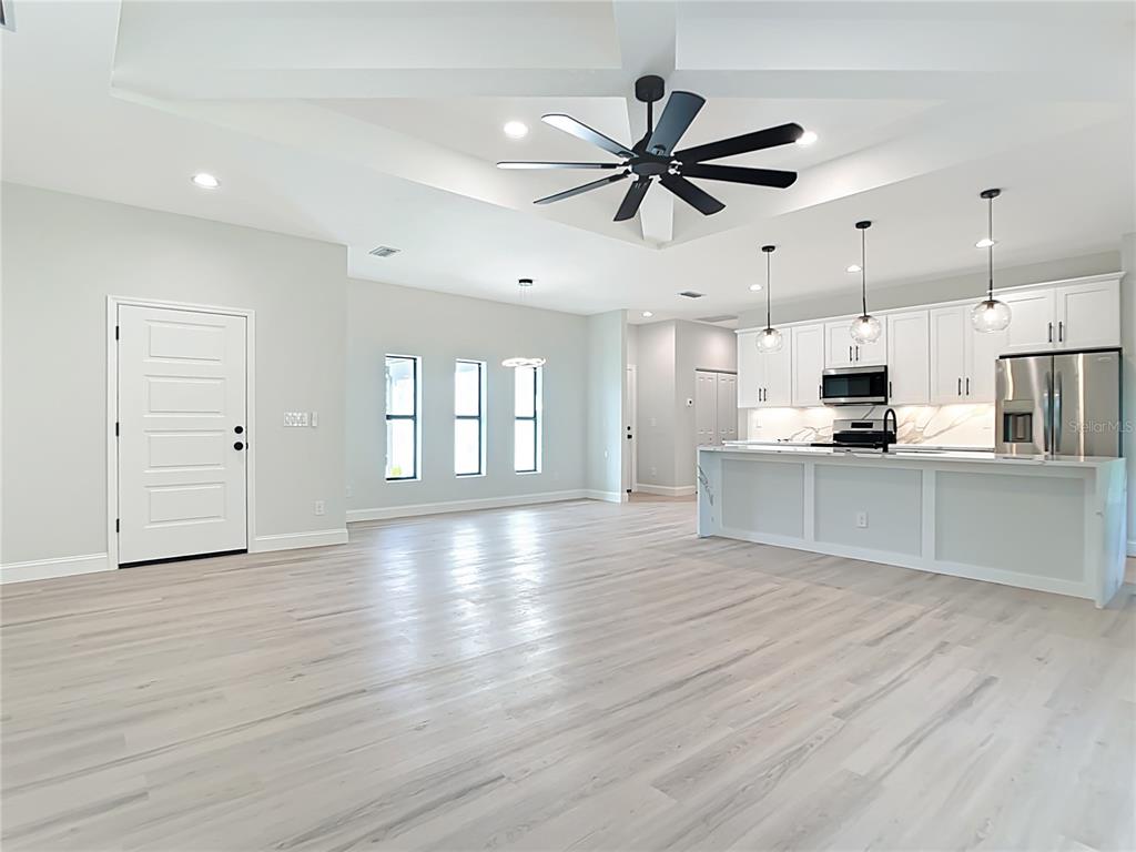 6231 Rowe Street Englewood, FL 34224 - Photo 10 of 35 a view of a kitchen with a sink and wooden floor