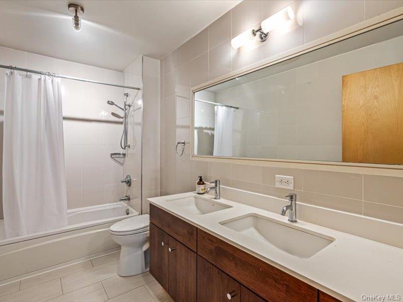 14 Hope Street, Unit 3F Brooklyn, NY 11211 - Photo 10 of 18 a bathroom with a double vanity sink toilet mirror and shower