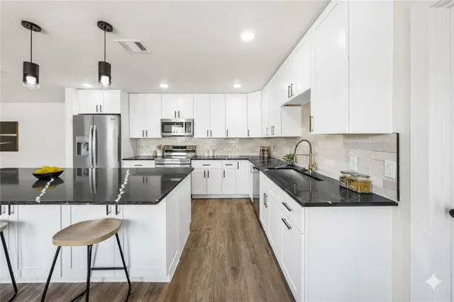 a view of an empty room with closet and a window