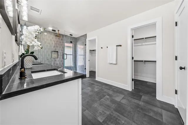 a view of a livingroom with wooden floor and furniture