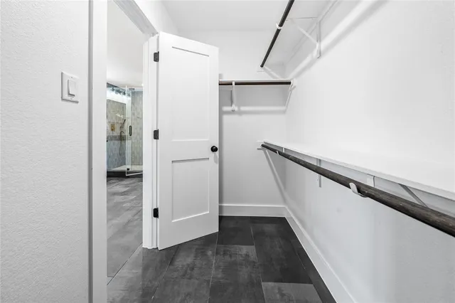 a bathroom with a granite countertop toilet sink and mirror