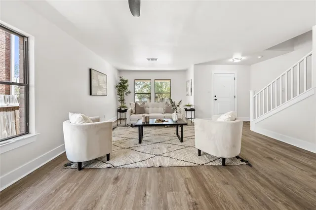 a living room with furniture and wooden floor