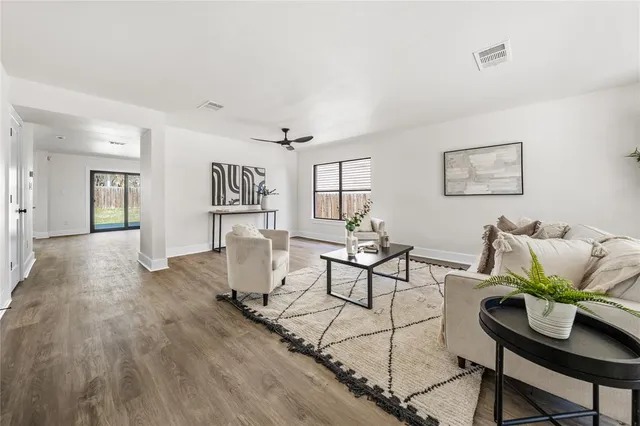 a large kitchen with stainless steel appliances granite countertop a sink a stove and a refrigerator