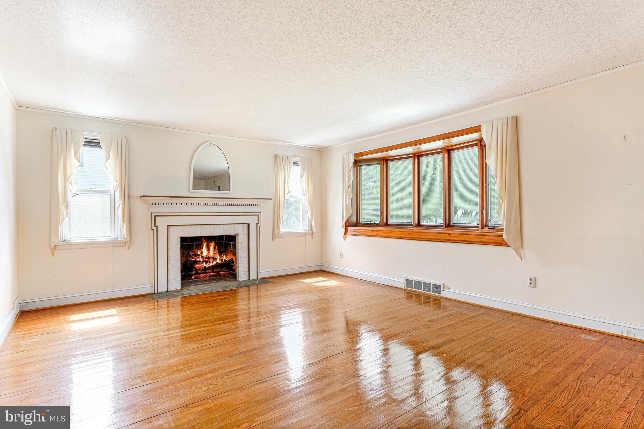 543 Hempstead Road Springfield, PA 19064 - Photo 7 of 31 Large bow windows and fireplace in the living room