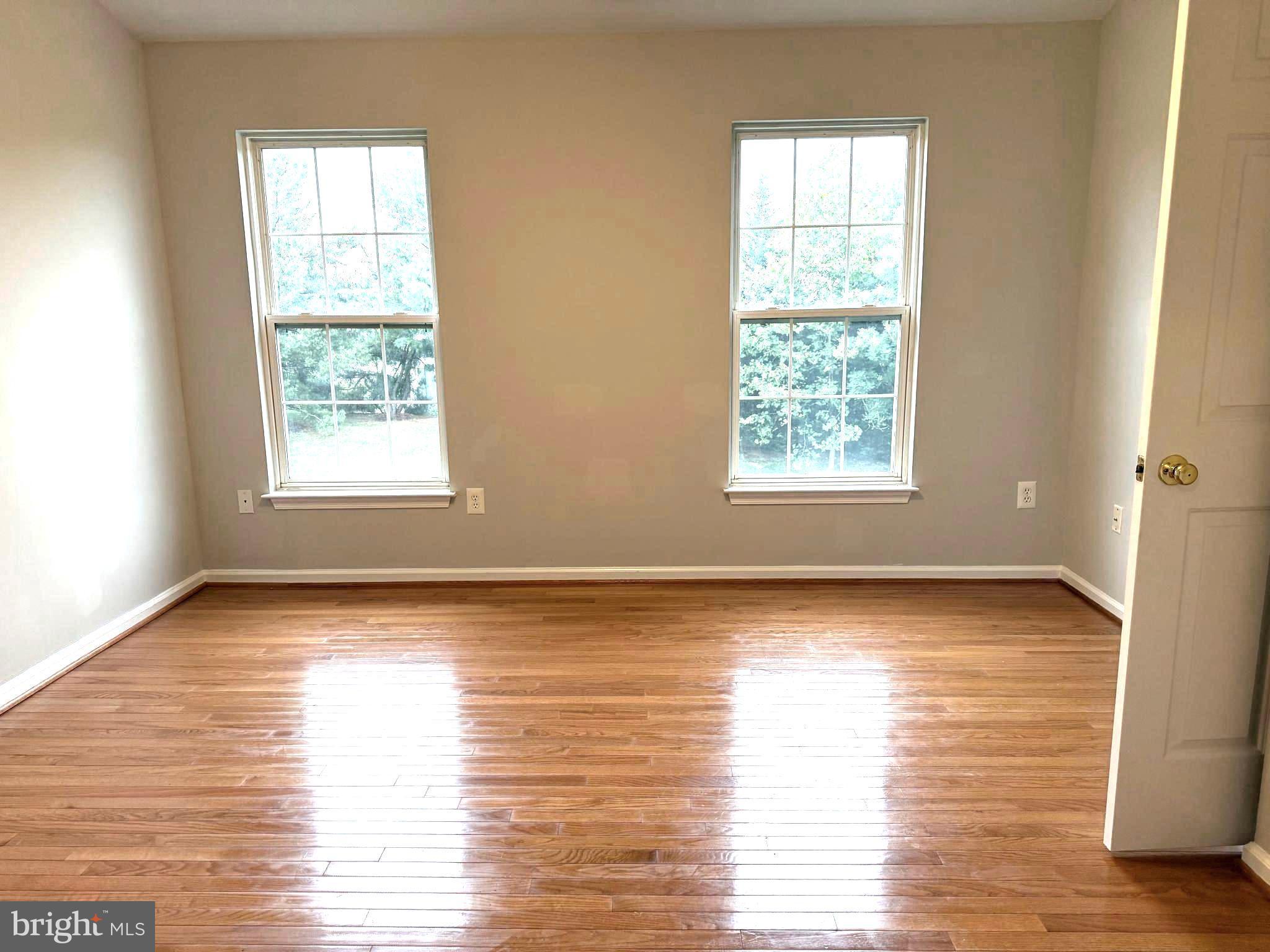 5992 Autumn Spell Elkridge, MD 21075 - Photo 13 of 30 a view of an empty room with wooden floor and a window