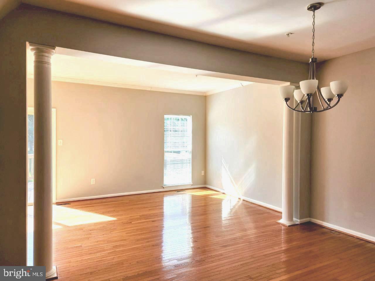 5992 Autumn Spell Elkridge, MD 21075 - Photo 4 of 30 a view of empty room with wooden floor and fan