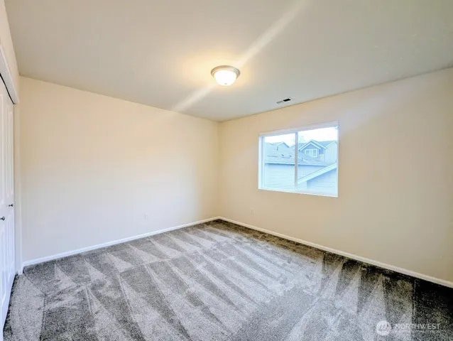 a bathroom with a sink a toilet a mirror and shower