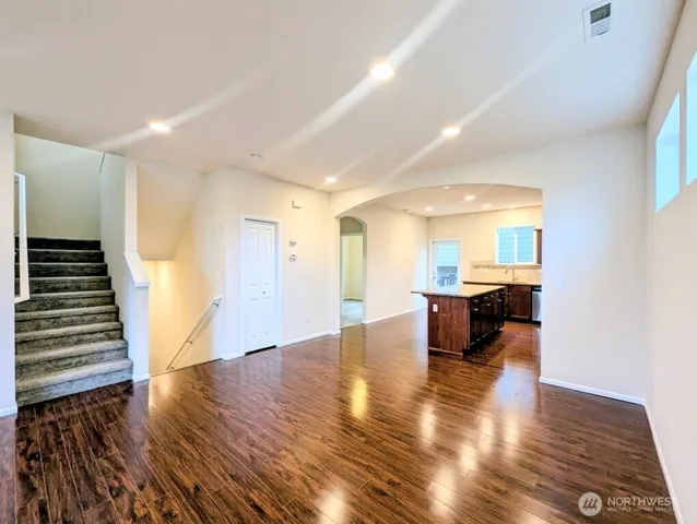 a view of kitchen and dining room with wooden floor
