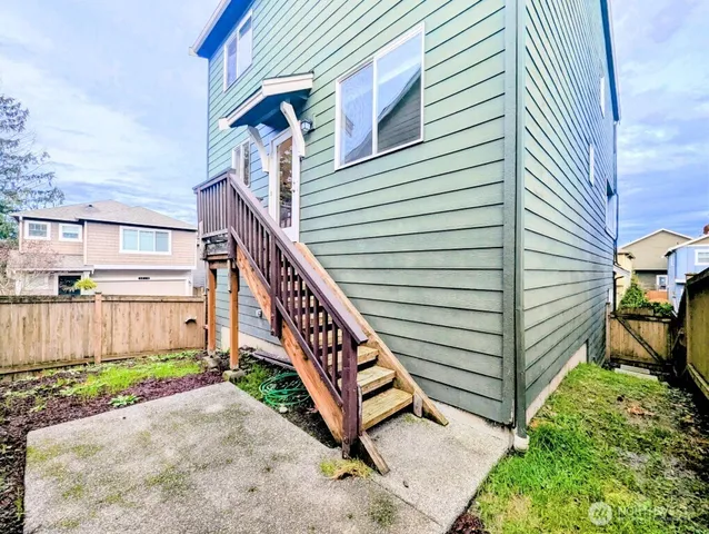 a view of a house with wooden fence