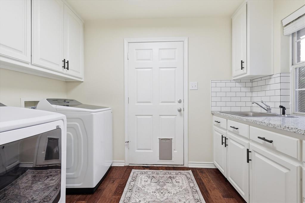 202 Colonial Heights Sanger, TX 76266 - Photo 18 of 27 a utility room with granite countertop cabinets washer and dryer