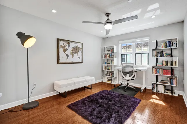 a view of entryway and hall with wooden floor