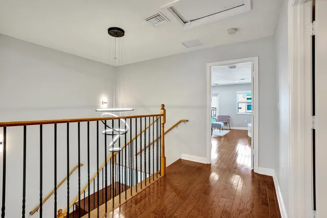 a living room with furniture a rug and a book shelf