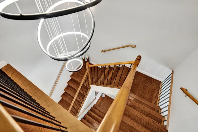 a kitchen with granite countertop a refrigerator stove and white cabinets