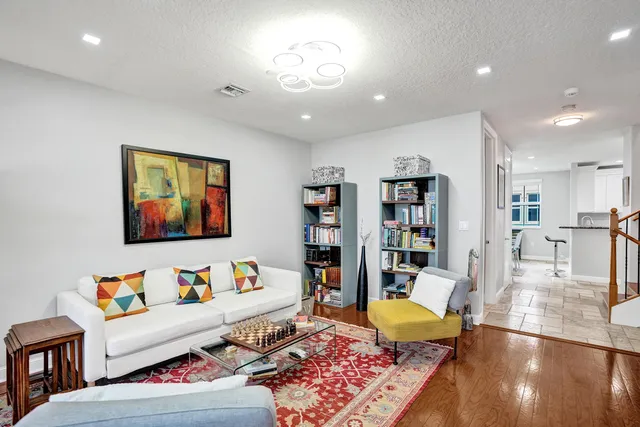 a kitchen with granite countertop a sink stove and refrigerator