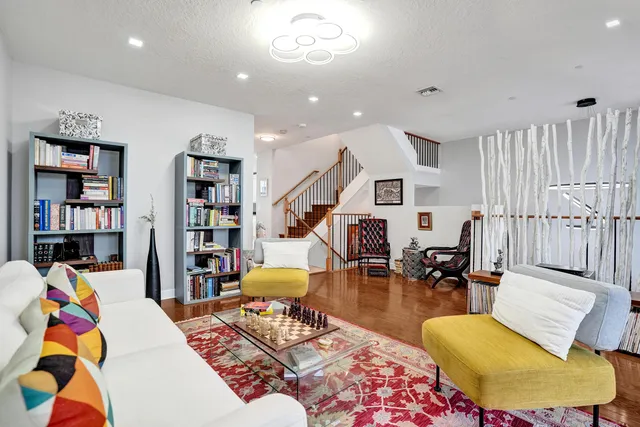 a kitchen with granite countertop white cabinets and stainless steel appliances