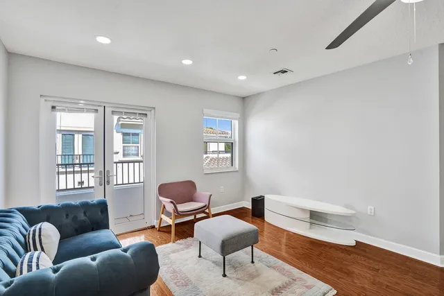 a living room with furniture a rug and a book shelf