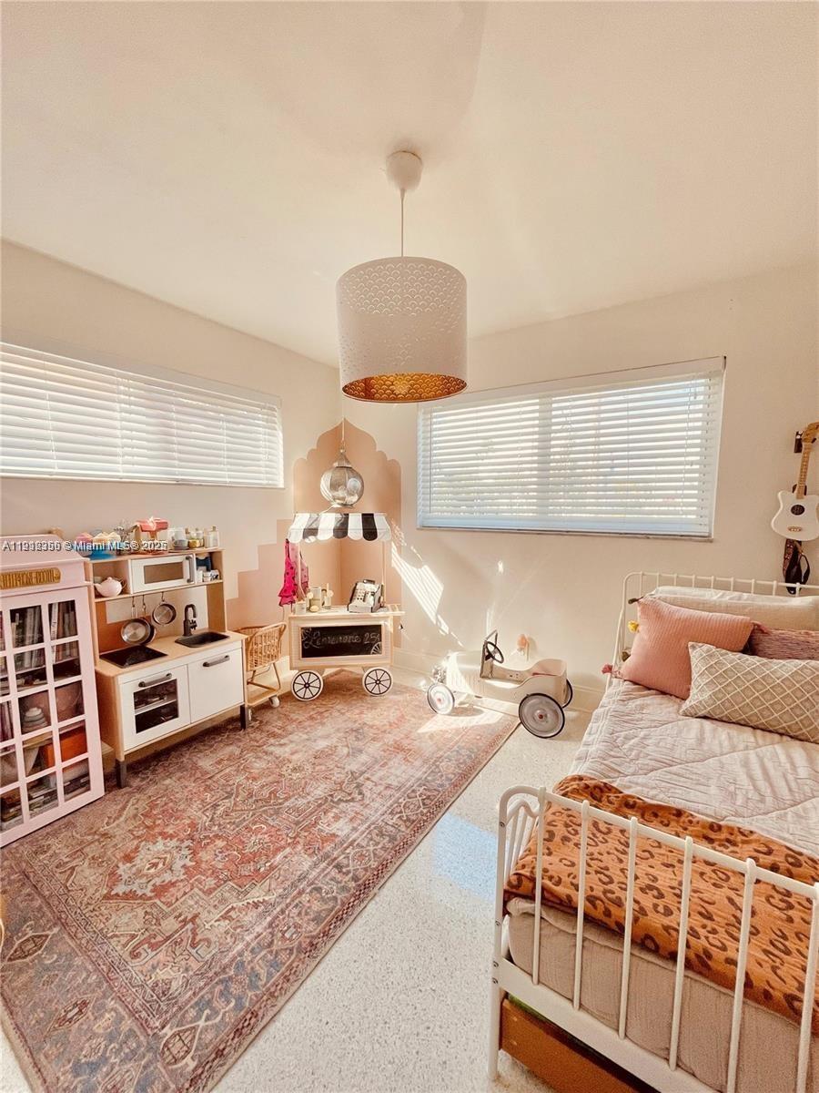 207 Southwest 12th Avenue, Unit 207 Dania Beach, FL 33004 - Photo 11 of 13 a bedroom with furniture and a table