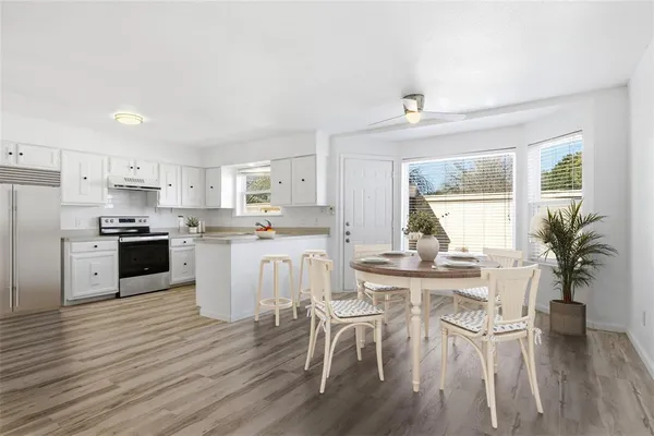 a kitchen with white cabinets and stainless steel appliances