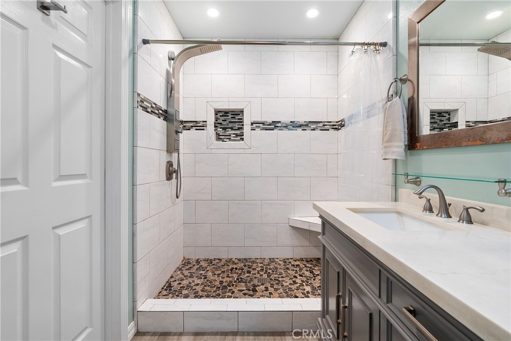 3388 Ramona Road Atascadero, CA 93422 - Photo 32 of 55 The ensuite bathroom boasts a fantastic walk-in shower with a clever niche and powerful shower system.