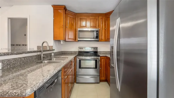 a kitchen with a refrigerator and a sink