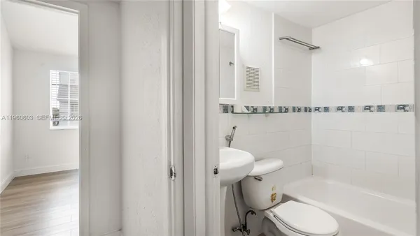 a bathroom with a shower a toilet and a shower