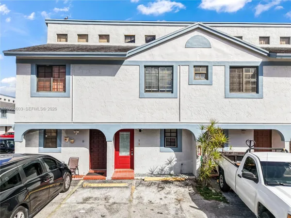 a front view of a house with parking space