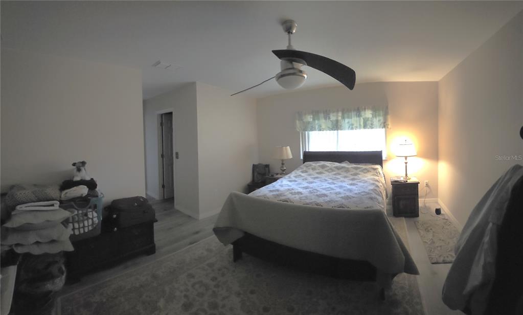 11263 Southwest 138th Lane Dunnellon, FL 34432 - Photo 14 of 25 a bed sitting in a bedroom next to a window