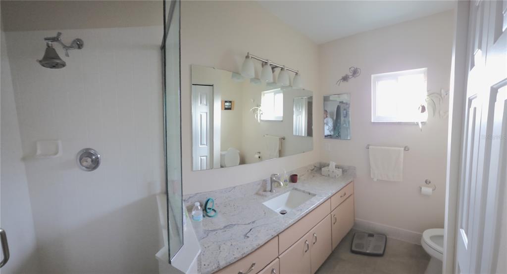 11263 Southwest 138th Lane Dunnellon, FL 34432 - Photo 16 of 25 a spacious bathroom with a double vanity sink toilet and shower