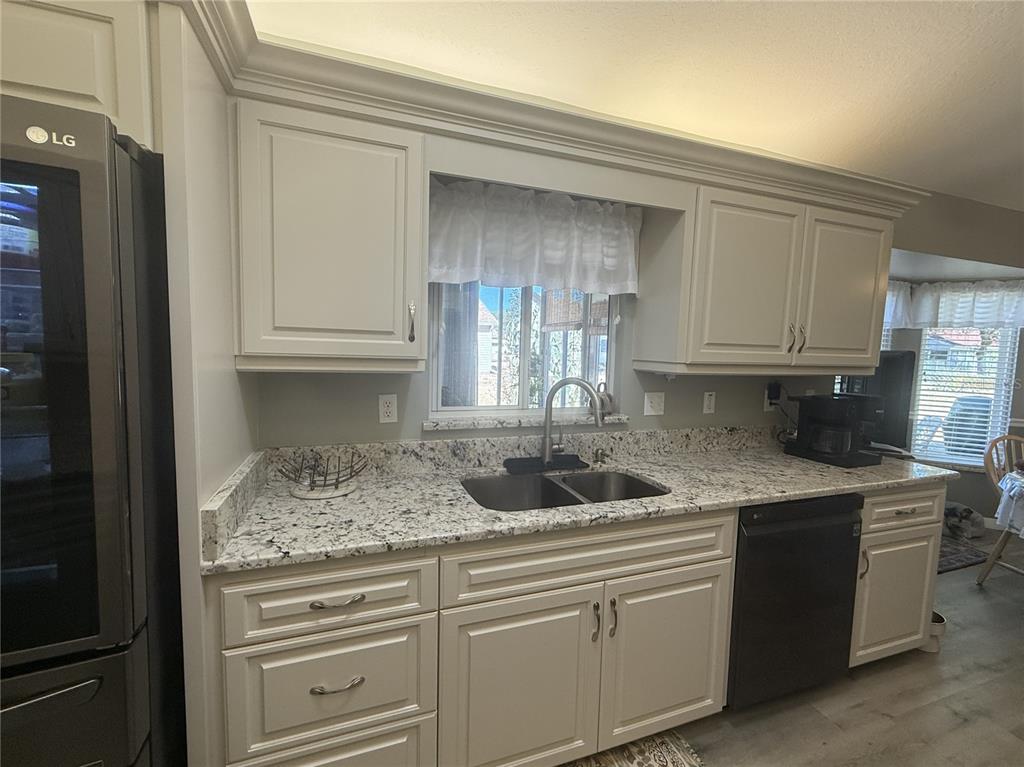 11263 Southwest 138th Lane Dunnellon, FL 34432 - Photo 4 of 25 a kitchen with granite countertop a sink and cabinets
