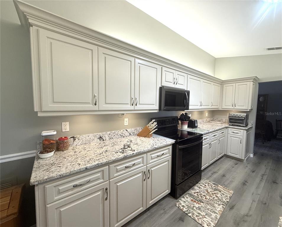 11263 Southwest 138th Lane Dunnellon, FL 34432 - Photo 6 of 25 a kitchen with granite countertop cabinets stainless steel appliances and a counter space