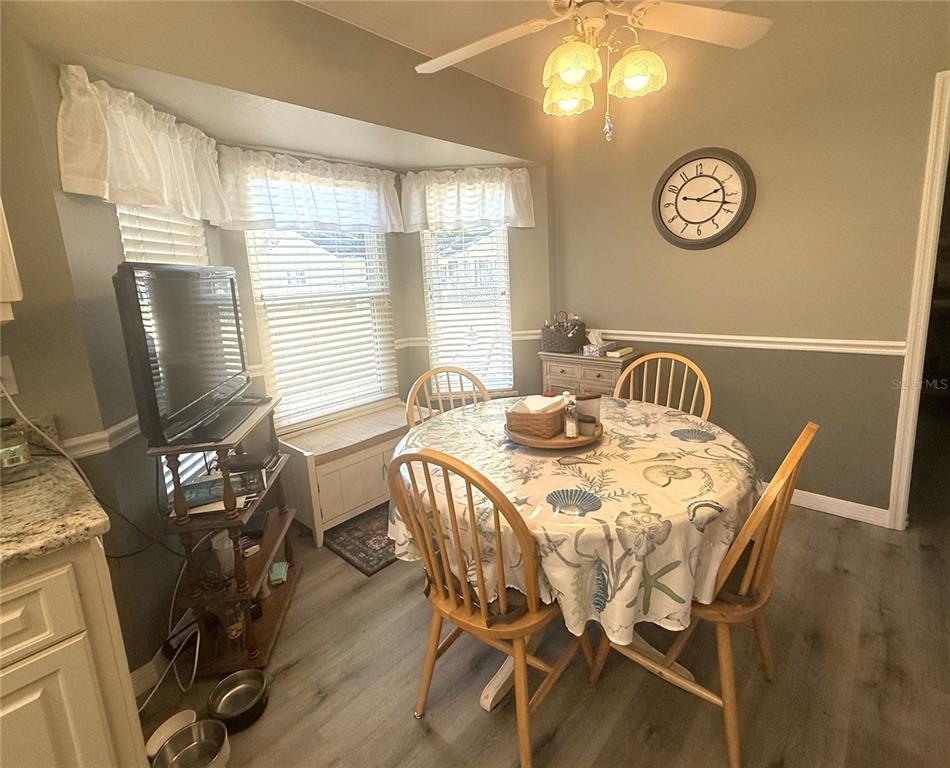 11263 Southwest 138th Lane Dunnellon, FL 34432 - Photo 7 of 25 a view of a dining room with furniture window and wooden floor