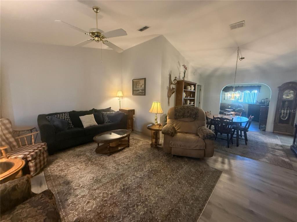 11263 Southwest 138th Lane Dunnellon, FL 34432 - Photo 10 of 25 a living room with furniture and a chandelier